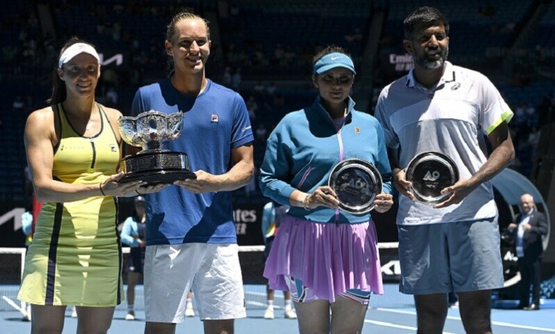  (L-R) Brazil’s Luisa Stefani and Rafael Matos pose with the trophy after their victory against India’s Sania Mirza and Rohan Bopanna during the mixed doubles final on day twelve of the Australian Open tennis tournament in Melbourne on Friday. — AFP 